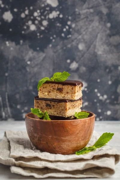 Raw vegan cake with chocolate, a stack of sliced pieces