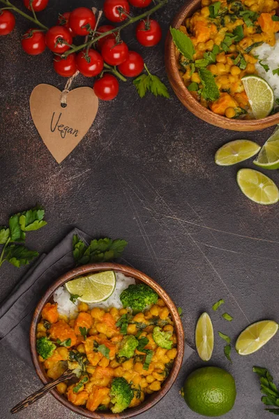 Vegan Sweet Potato Chickpea curry in wooden bowl on a dark
