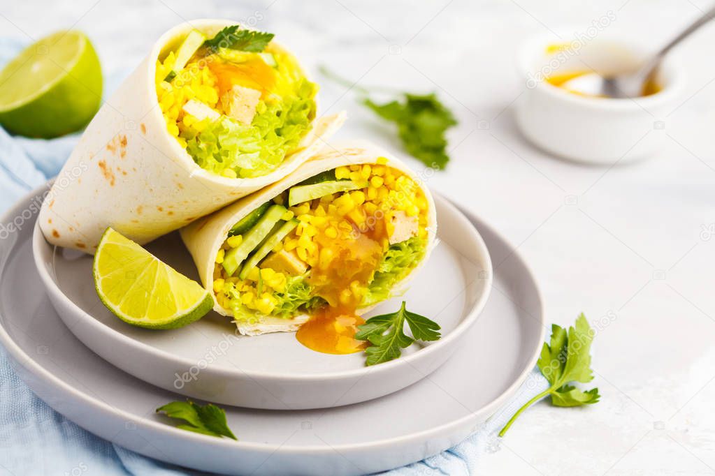 Healthy vegan wraps (burrito) with bulgur, curry sauce and baked