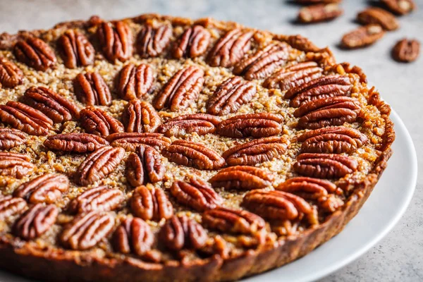 Pecan Pie on gray-brown background. Vegan dessert concept.