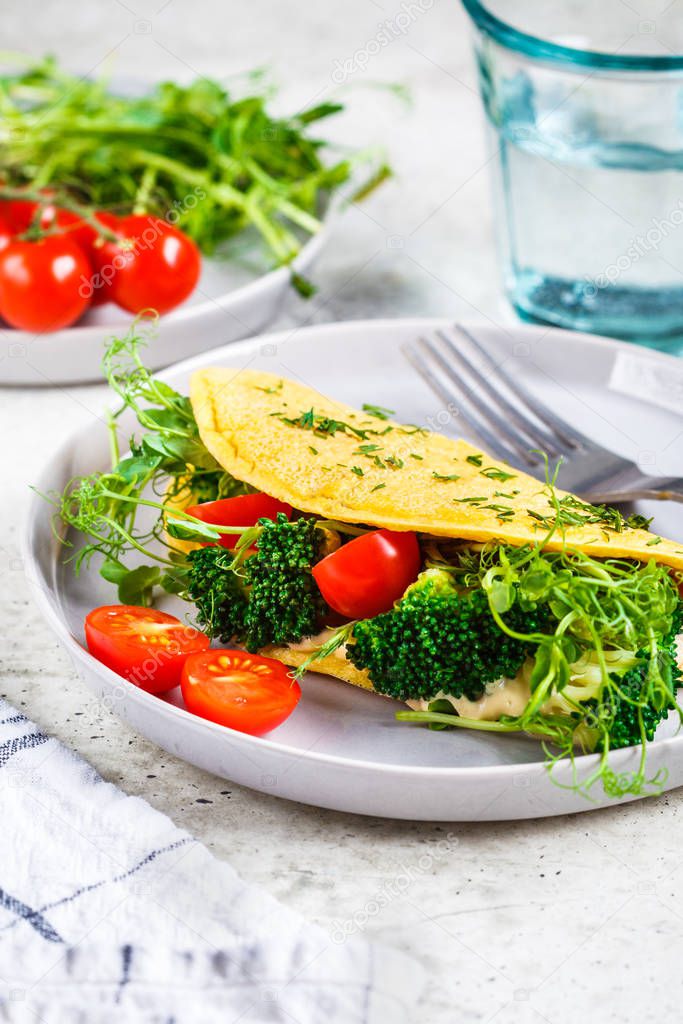 Omelet with broccoli, tomatoes and seedlings. Healthy vegan food