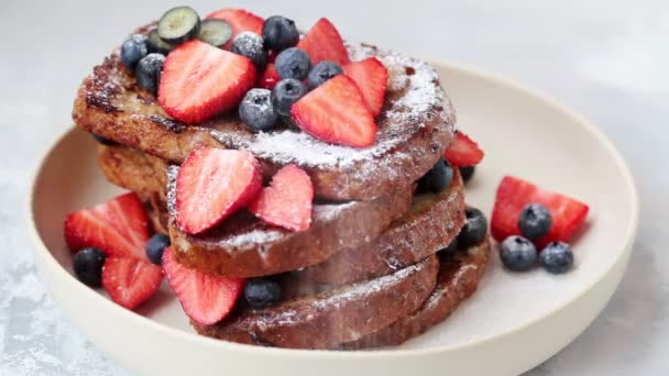 Französische Toasts mit Blaubeeren und Erdbeeren, mit Puderzucker bestreut. — Stockvideo