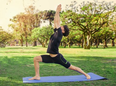 Yakışıklı delikanlı parkta yoga yaparken 