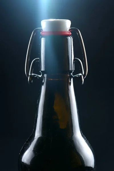 Beer bottle with lid dark glass on a dark background — Stock Photo, Image