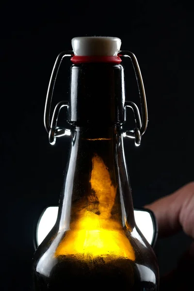 Beer bottle with lid dark glass on a dark background — Stock Photo, Image