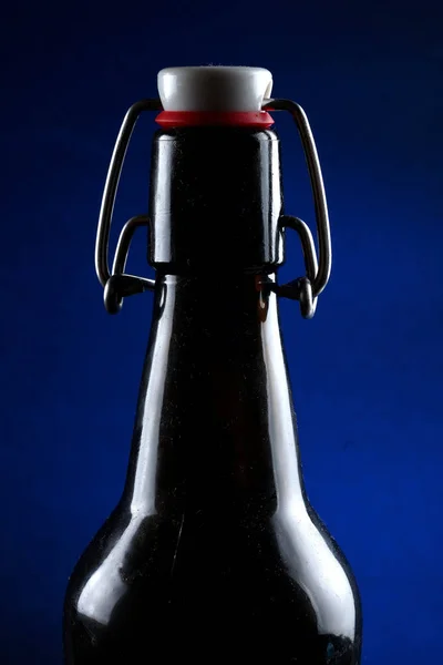 Beer bottle with lid dark glass on a dark background — Stock Photo, Image