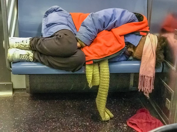 Manhattan, NY US - January 30, 2018 Homeless person sits in a subway car — Stock Photo, Image