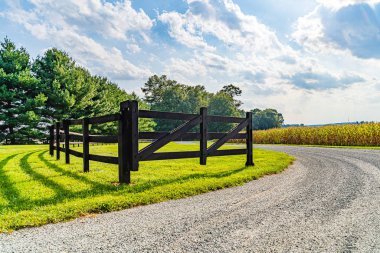 Amish country field agriculture, beautiful brown wooden fence, farm, barn in Lancaster, PA US clipart