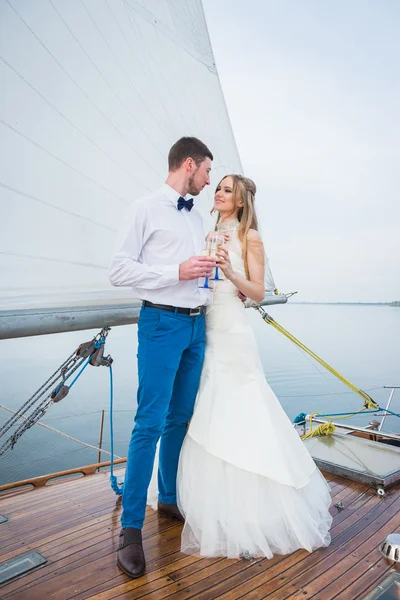 幸せな花嫁と花婿、ヨットの上で抱いて - お互いに探しています ストック写真
