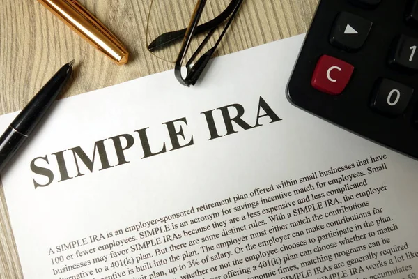 Simple ira document with pen calculator and glasses