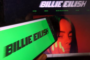 KONSKIE, POLAND - January 11, 2020: Billie Eilish logo on mobile phone clipart