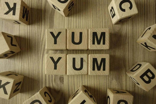 Text Yum yum from wooden blocks — 스톡 사진