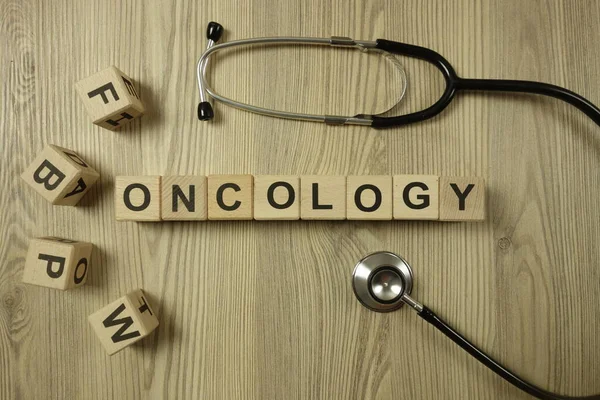 Word oncology from wooden blocks with stethoscope, healthcare and medical concept