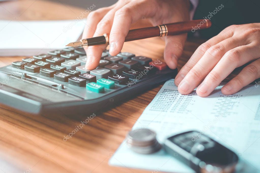 Businessman's hands with calculator and cost at the office and F