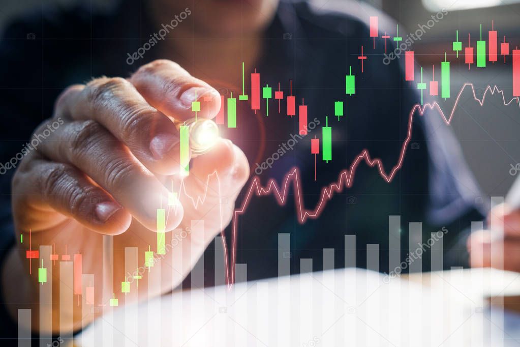 Businessman writing the trading graph of stock market on the vir
