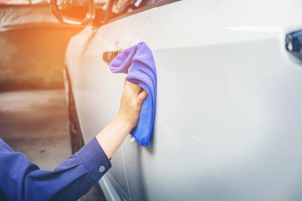 Ο άνθρωπος τον καθαρισμό αυτοκινήτου με microfiber πανί λευκό αυτοκίνητο — Φωτογραφία Αρχείου