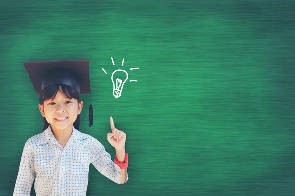 Asian Young girl has a bright idea as she stands against the bla — Stock Photo, Image