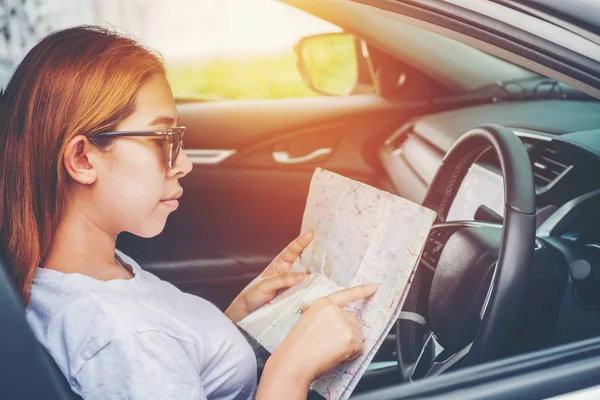 Fiatal nő egyedül autó utas térképet ferdehátú autó — Stock Fotó