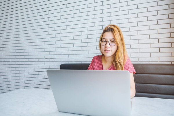 Asian girl working at a coffee shop with a laptop.female freelan