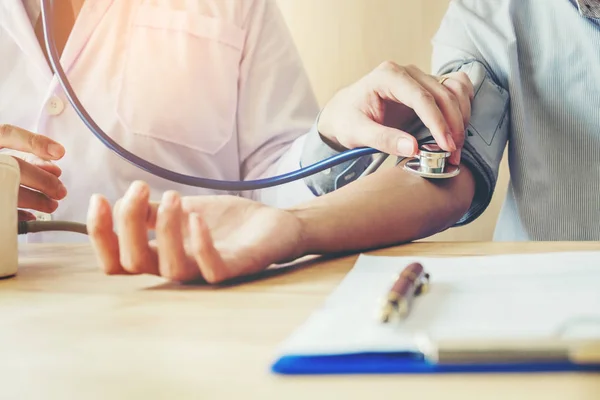 Arzt misst arteriellen Blutdruck Patientin rechts — Stockfoto