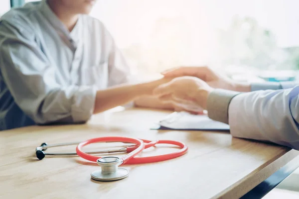 Doctor holding hands for comforting and care patient — Stock Photo, Image