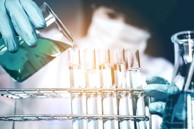 Bilim adamı bilimsel experim sırasında araçları tutarak ekipman ile