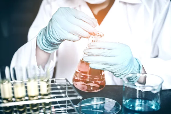 Scientist with equipment holding tools during scientific experim