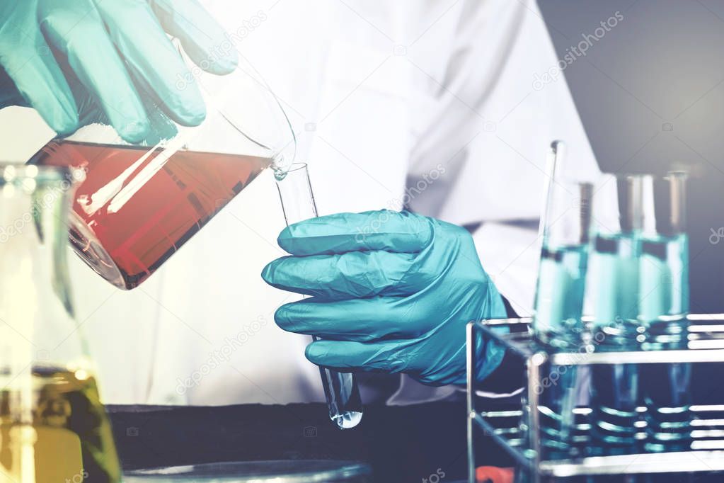 Scientist with equipment holding tools during scientific experim