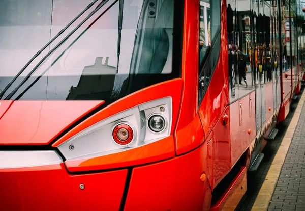 Public transport, tramway on a city street, headlights closeup.