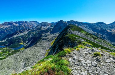 Amazing alpine mountain landscape, sunny hiking trail to the top