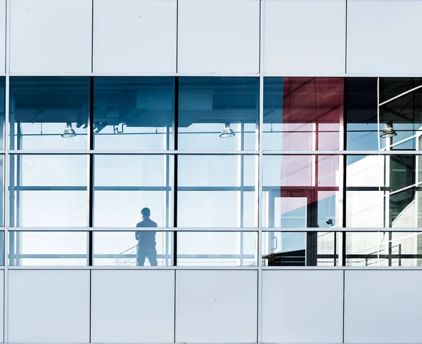 Person silhouette in the modern office window