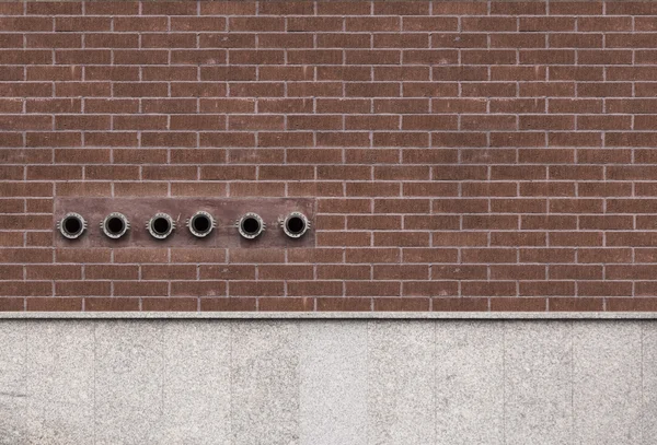 Brick wall with fire hydrants for emergency use