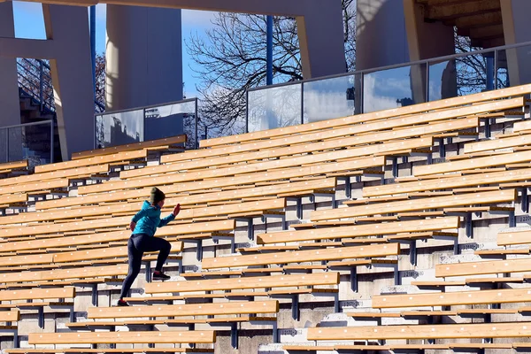 Young woman training on stairs.