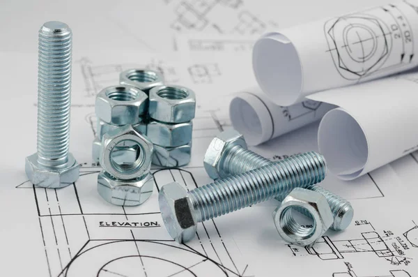 Mechanical Engineering Technology. Nuts and bolts on paper drawings — Stock Photo, Image