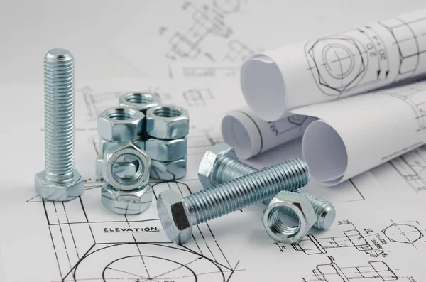 Mechanical Engineering Technology. Nuts and bolts on paper drawings — Stock Photo, Image