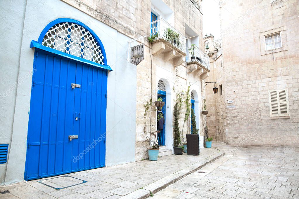 Malta blue door and white walls, street typical Maltese archtecture. 