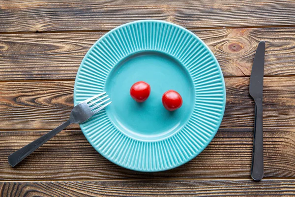 Kleine Portion Tomaten Auf Türkisfarbenem Teller Auf Holztisch Draufsicht Ernährungskonzept — Stockfoto