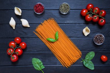 Makarna, büyük koni ve taze sebze. İtalyan mutfağı için malzemeler, üst manzara. Siyah tahta arkaplan. 