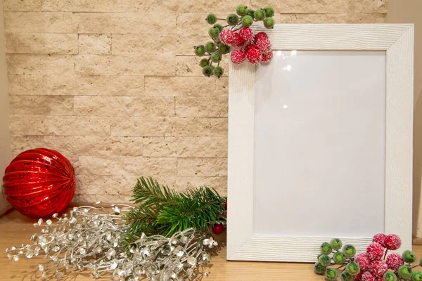 Noel modeli, köknar dalları, gümüş Noel dekoru ve kırmızı ve yeşil dut çerçeveli kırmızı cam Noel topu, tuğla duvar arka planı. 