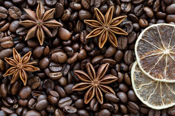 Coffee beans, anise stars and dried lime slices, close up, macro. Christmas concept.