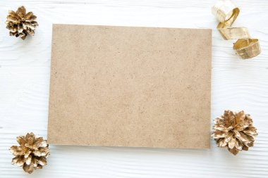 Noel yatağı, karşılama yeri, fotokopi alanı. Beyaz ahşap zemin üzerinde altın koniler. 