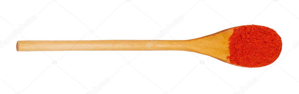 Isolated wooden spoon with ground red pepper 