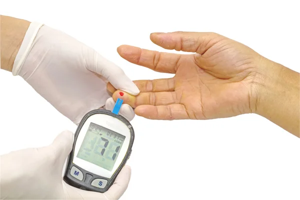Blodsockermätare, blodsocker värdet mäts på ett finger av kvinnliga läkare i vita medicinska handskar Stockfoto