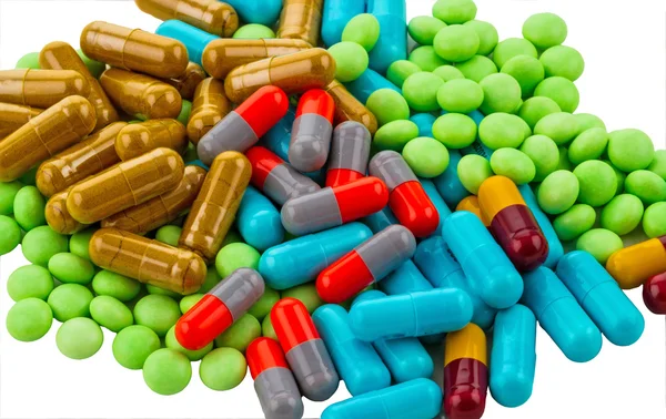 Muitos medicamentos coloridos no fundo branco — Fotografia de Stock