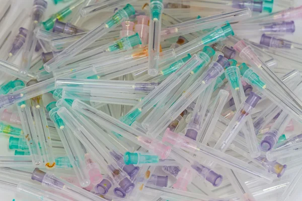 Close up many medical syringe needle isolated on white