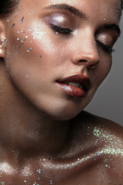 Girl with fashion glitter makeup with sequins