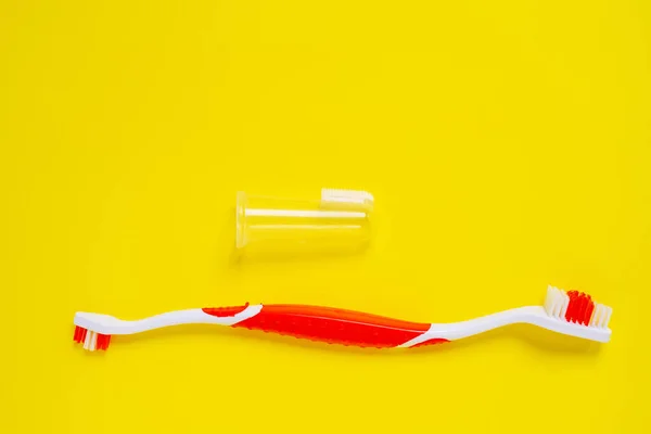 Set of toothbrush for pets on a yellow background. Concept of pet dental hygiene to prevent health issues. — Stock Photo, Image