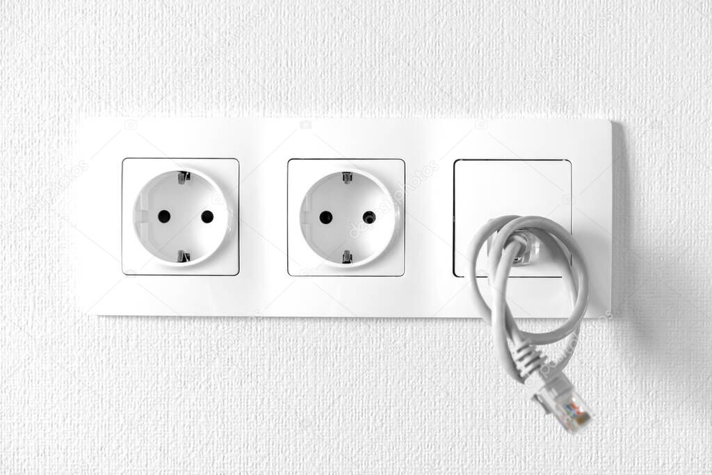 Electric sockets and internet outlet built into a single unit.