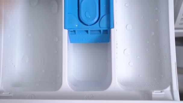 Top view of washing machine with human hands putting detergents inside. — Stock Video