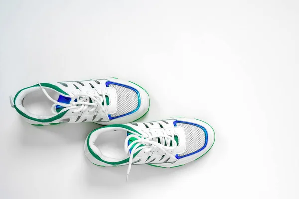 Nya snygga färgglada sneakers på vit bakgrund. Platt låg, ovanifrån, kopiera utrymme minimal bakgrund. Begreppet kärlek springa och riktningar rörelser — Stockfoto